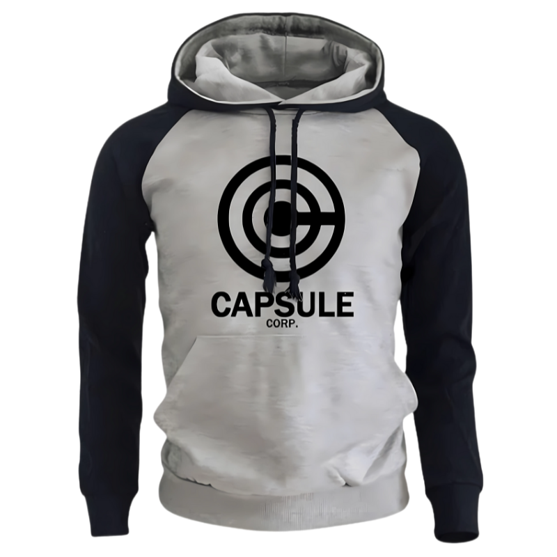 Sweat à capuche bicolore avec un corps gris clair et des manches navy, arborant un logo Capsule Corp noir centré sur le devant. Ce hoodie présente des cordons noirs assortis et une coupe moderne pour un confort optimal, idéal pour les amateurs de mode casual et de culture pop.