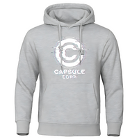 Sweat à capuche gris clair Capsule Corp avec logo glitché blanc, design moderne et inspiré de Dragon Ball.