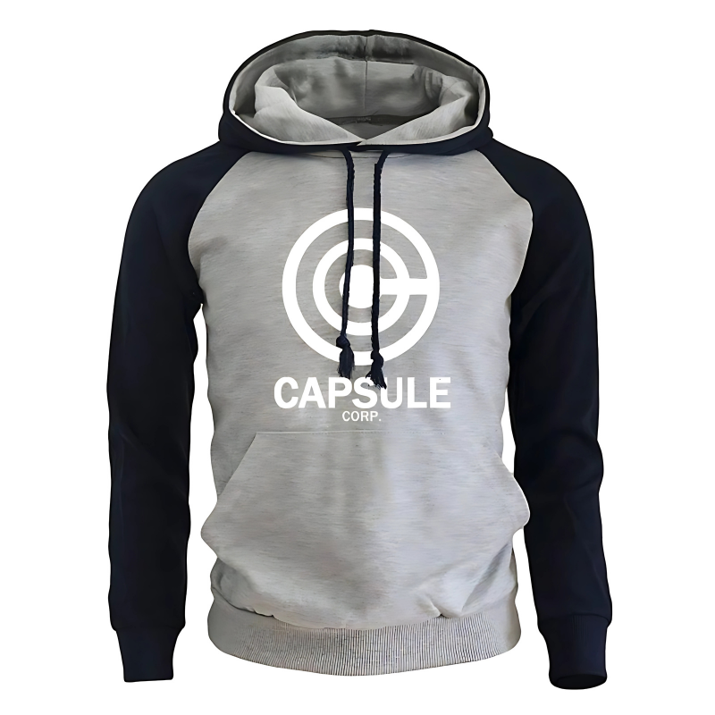 Sweat à capuche bicolore avec un corps gris clair et des manches navy contrastantes, orné du logo blanc Capsule Corp sur le devant. Le hoodie comporte une poche kangourou pratique et des cordons assortis noirs pour un look moderne et confortable, parfait pour les amateurs de mode geek.