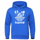 Sweat à capuche bleu vif avec logo représentant la maison de Kame (Tortue Géniale) et des palmiers, inspiré de l'univers Dragon Ball, parfait pour les fans de manga et d'anime.