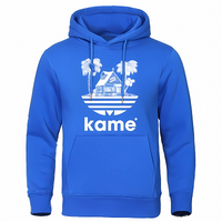 Sweat à capuche bleu vif avec logo représentant la maison de Kame (Tortue Géniale) et des palmiers, inspiré de l'univers Dragon Ball, parfait pour les fans de manga et d'anime.