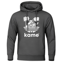 Sweat à capuche gris foncé avec logo représentant la maison de Kame (Tortue Géniale) entourée de palmiers, design inspiré de l'univers Dragon Ball, idéal pour un style casual et geek.

