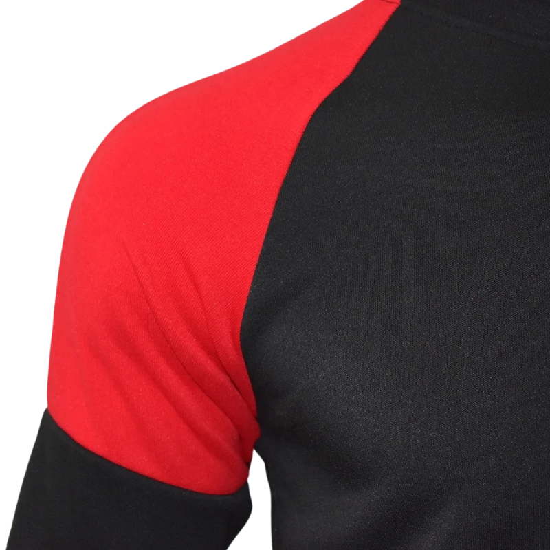Gros plan sur l'épaule du hoodie Dragon Ball noir et rouge, mettant en valeur les coutures soignées et le contraste des couleurs. Inspiré de l'univers de Goku et Dragon Ball Z.